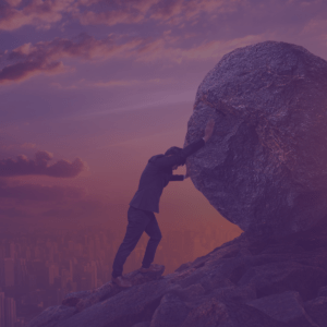 The image is of a man pushing a huge circular rock up a mountain. He is dressed in corporate clothes with a skyline behind him. This image is meant to visualise resilience against adversity, a core component of effective change leadership.